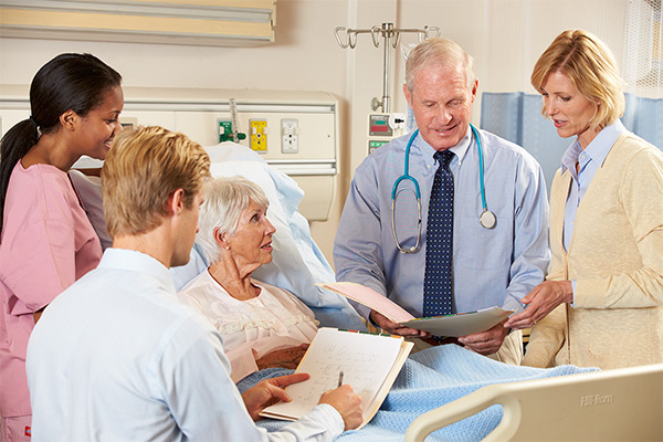 Doctor bedside with patient